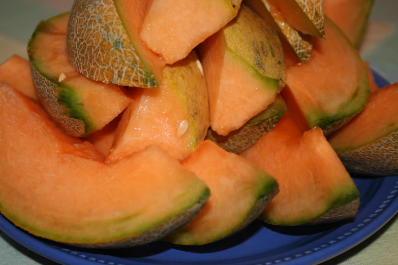 this fruit is cut in to pieces on a plate