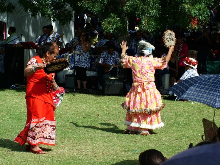 two women in costume with people watching