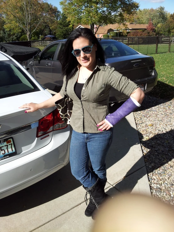 woman standing on a curb wearing sunglasses and knitted armwars