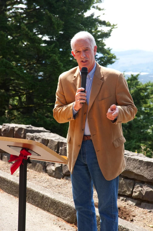 a man standing on a stage giving a speech