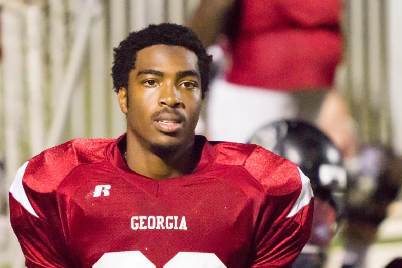 a close up of a man in red and white football uniform