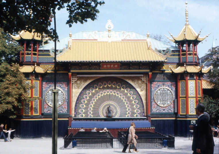 people standing outside in front of a large artistic building