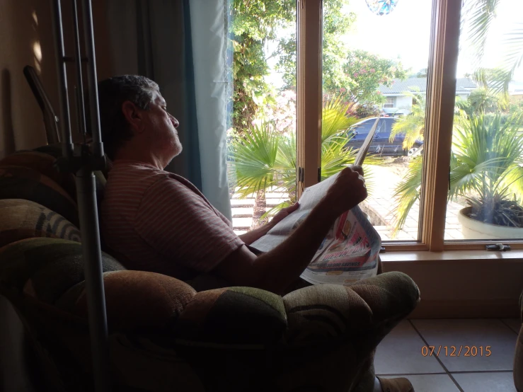 an older person sitting at a window sill with their leg wrapped up