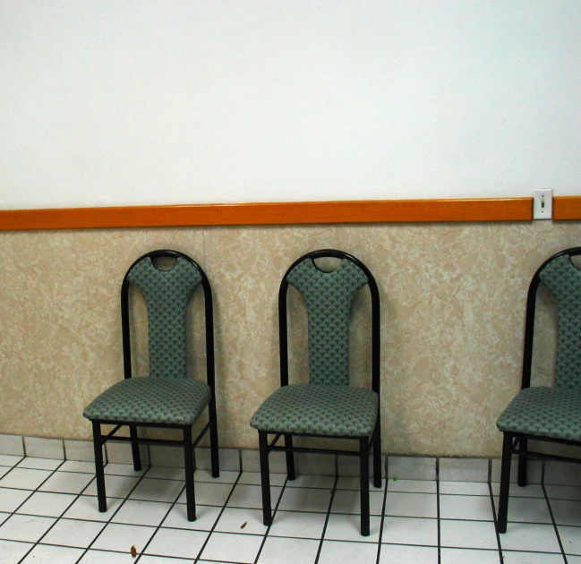 the chairs are all in a row near the wall
