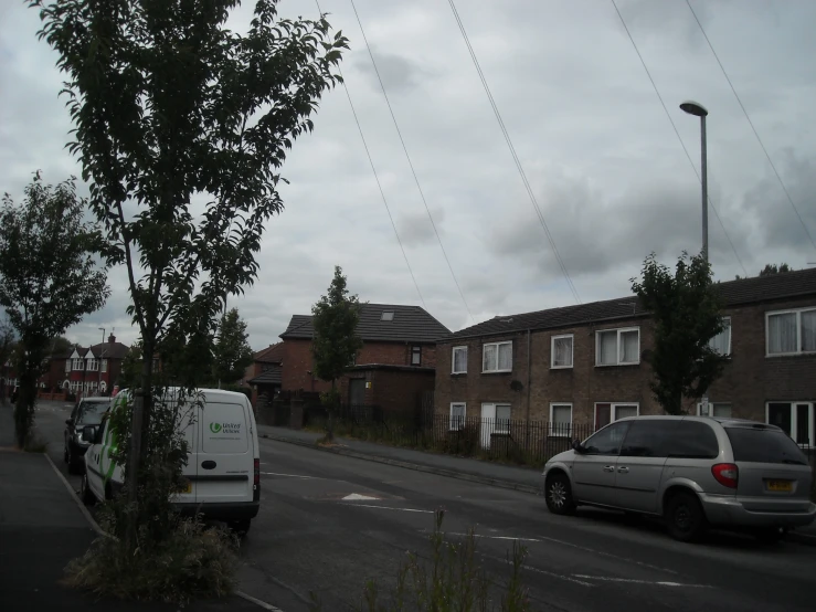 the vehicles on the side of the street are parked