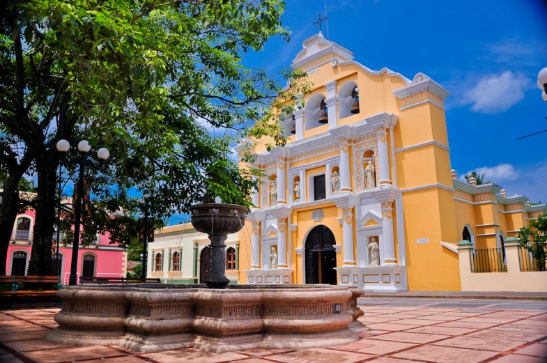 an old church with statues of horses and a fountain