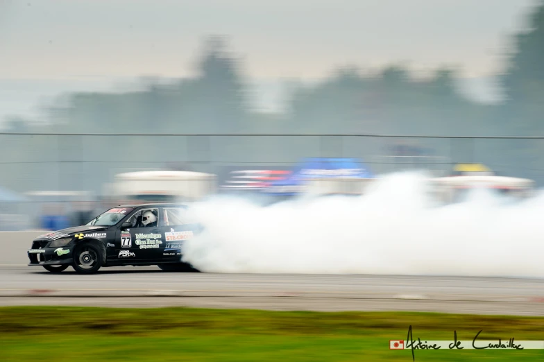 a man in a car driving around a track