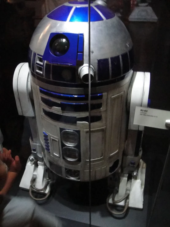 a robot from the movie star wars sits on display