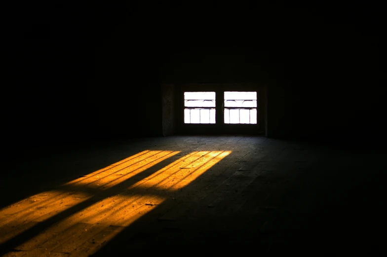 a light streaming through a window with no curtains on it