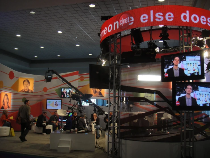 a television room with lots of monitors displaying the news