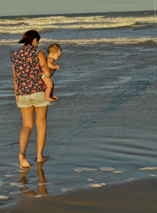 two adults and a child looking out at the water