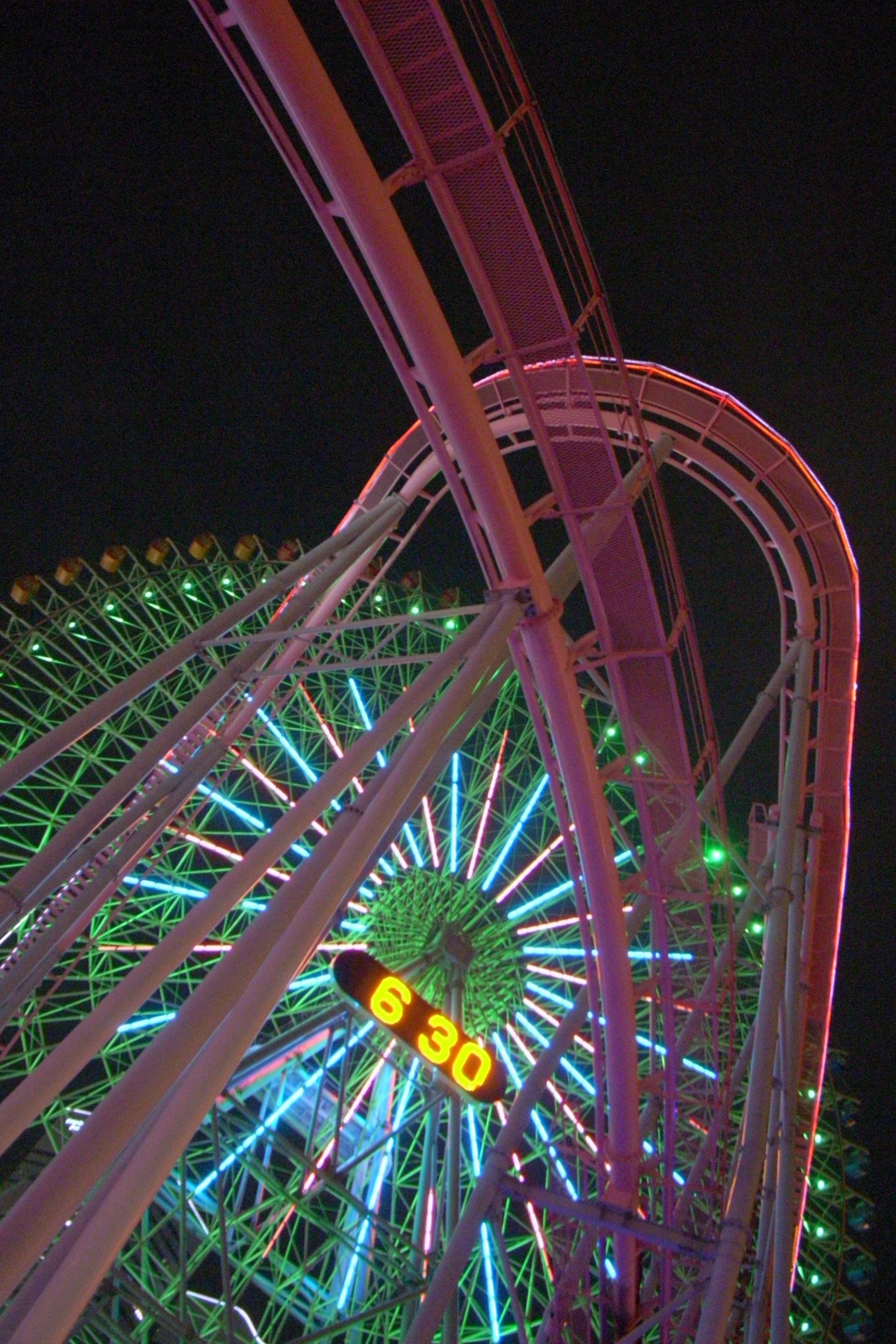 a ferris wheel is lit up and turned yellow