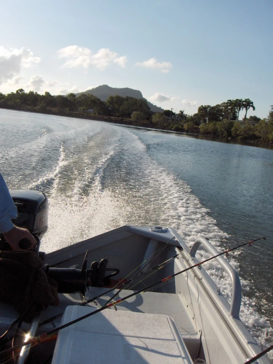 a boat riding on the water behind someone