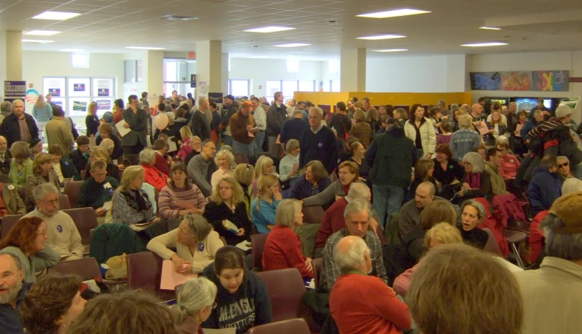 a big crowd of people gathered together inside of a building