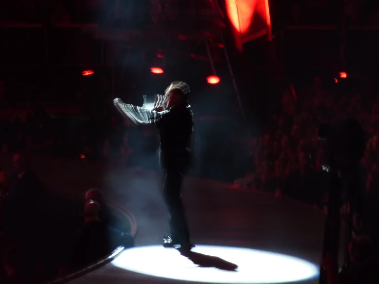 man standing in middle of stage during show