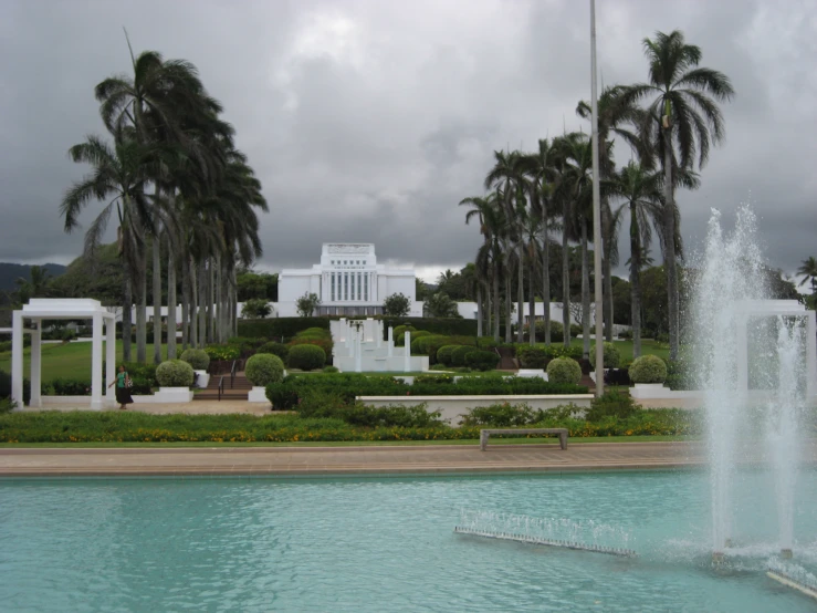 a fountain sits in front of a beautiful building