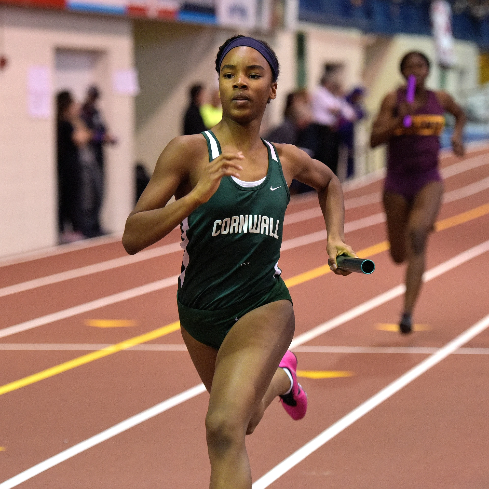 women running in a track event at a stadium