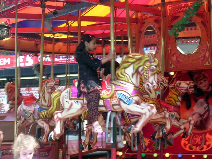 the horses are close together on the merry go round