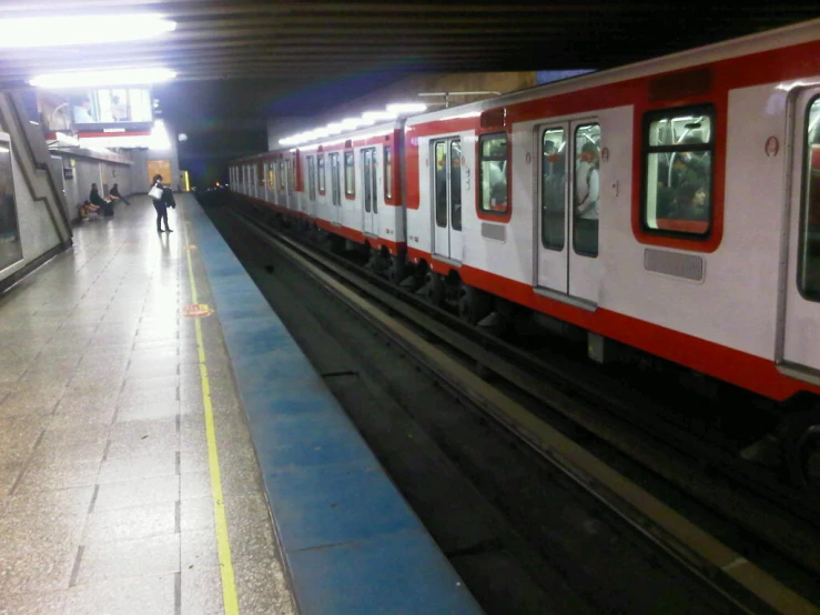 a red and white train at a train station