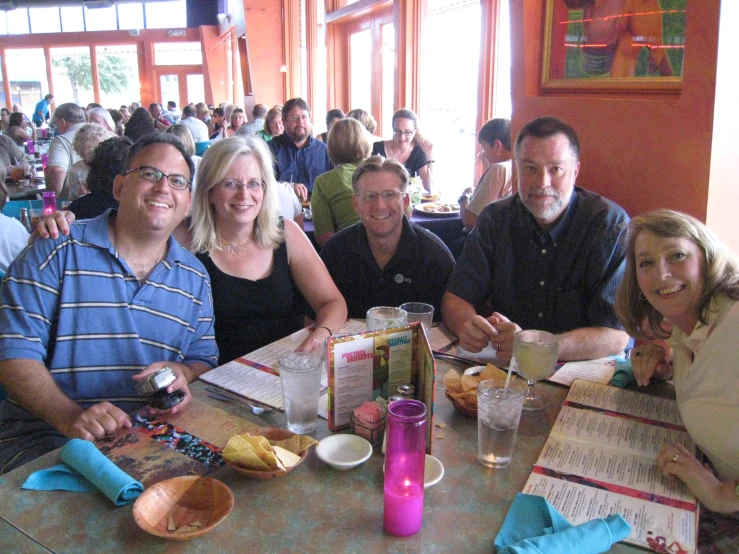 five people sitting at the table enjoying lunch