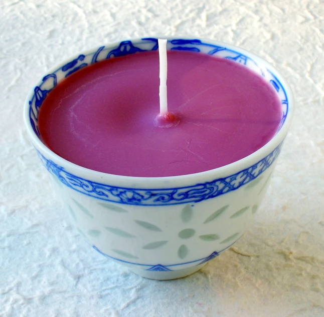 an open candle sticks in a blue and white bowl