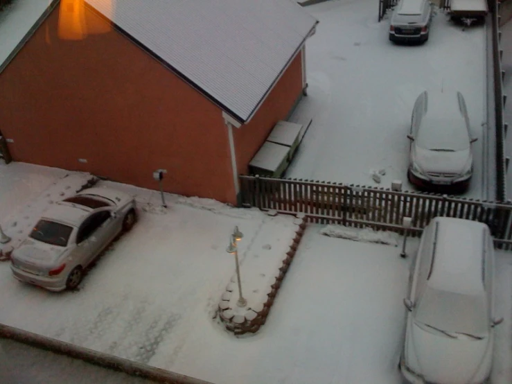 an overhead s of cars parked in front of a red house