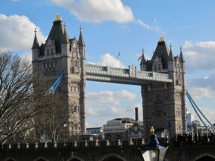 a tower bridge with two towers and blue ropes