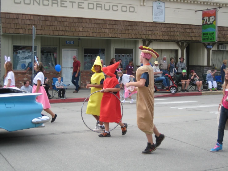people in costume are walking down the street in the daytime