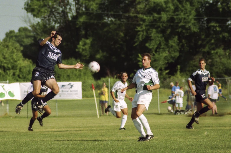 soccer players on field in uniform playing soccer