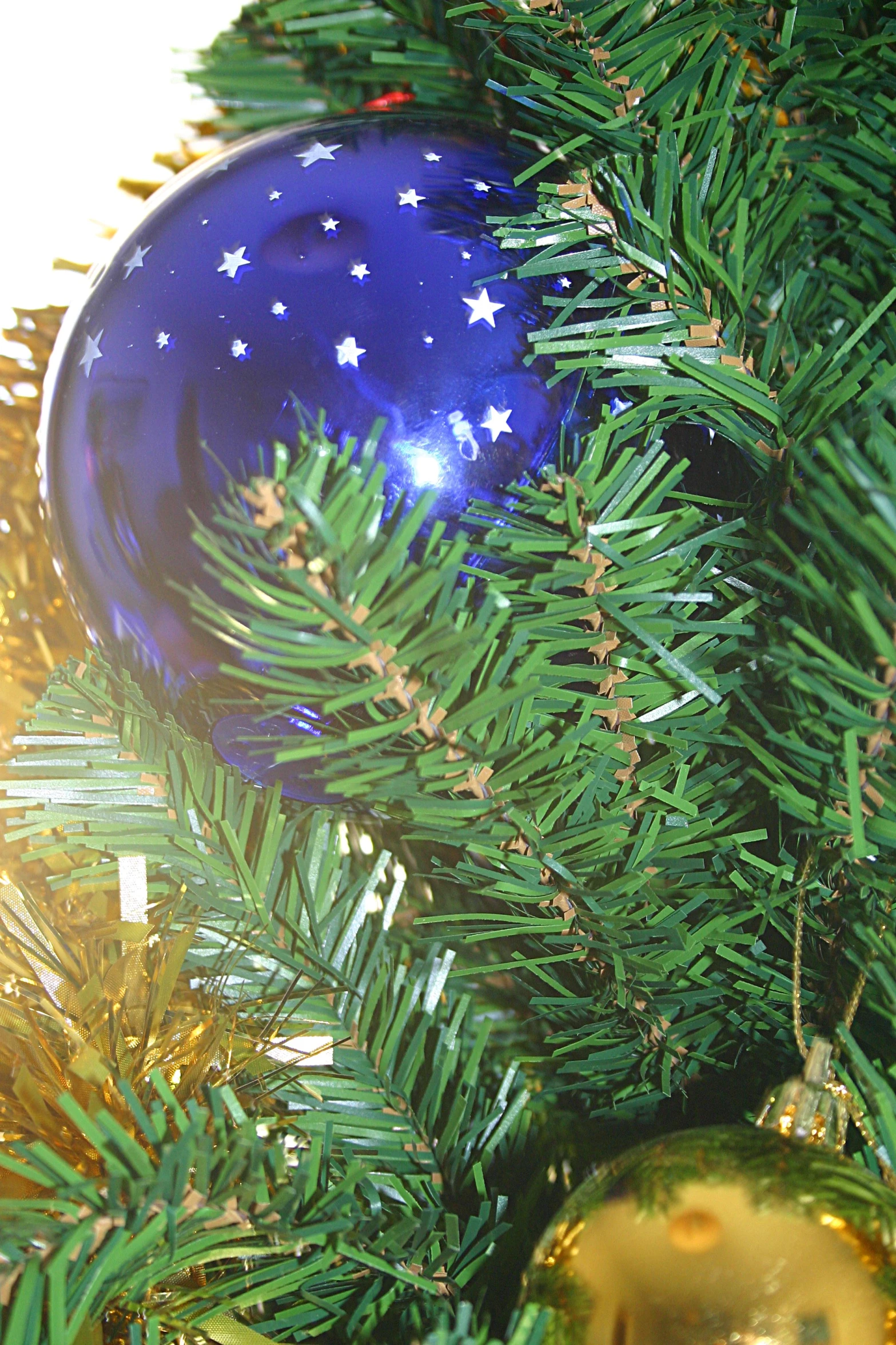 a christmas ornament sitting on top of a green pine tree