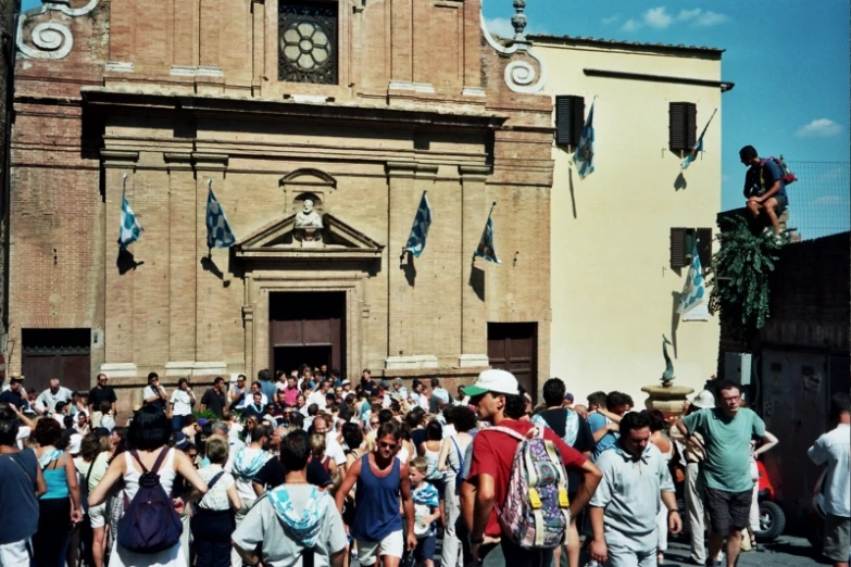 the people are outside walking around in front of the church