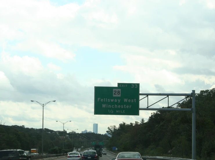 some cars going down a highway with a sign saying 20