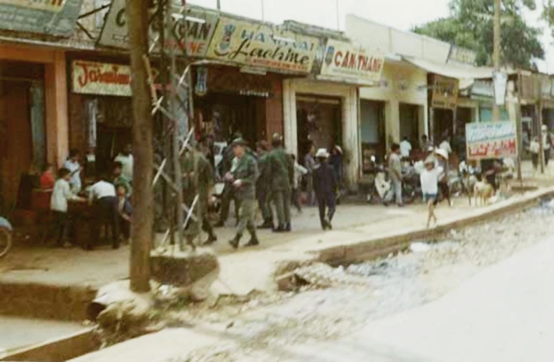 several men walking in line in front of shop fronts