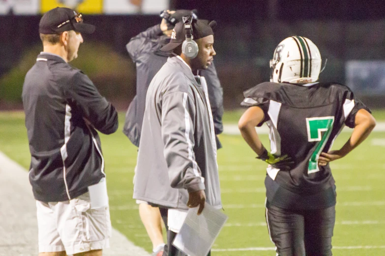 a coach talks to his team on the sidelines