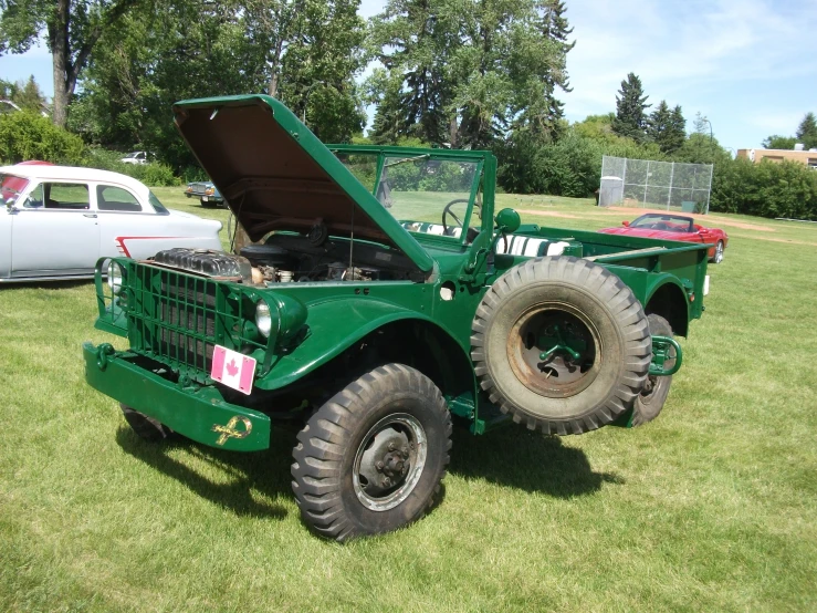 an army truck that is sitting in the grass