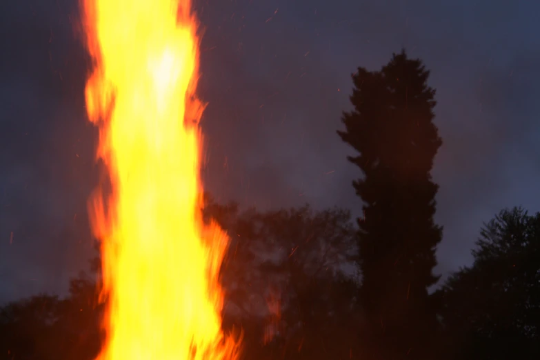a tall fire with lots of glowing yellow flames