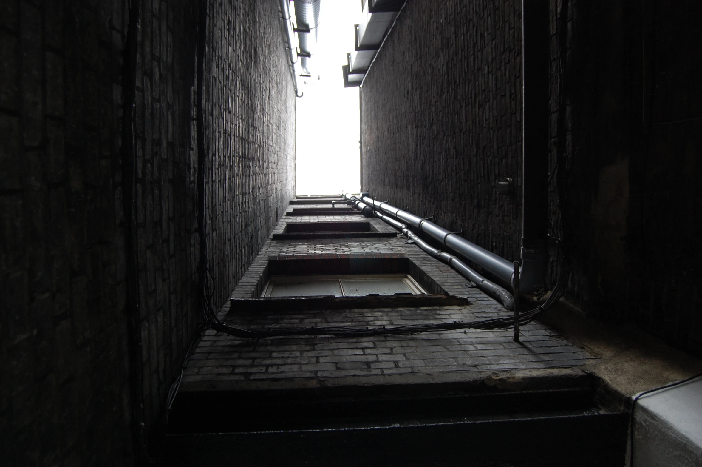 alleyway to an exit with the light filtering in