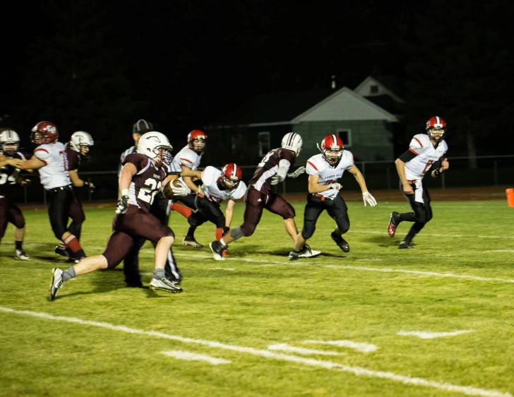 a football game with many players running on the field