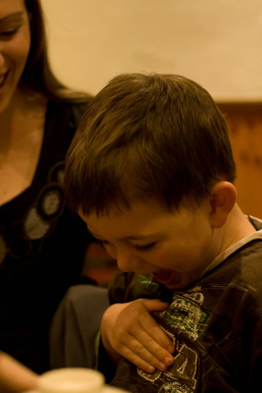 a child in front of his mom preparing to eat