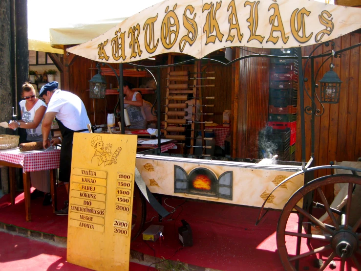 a small, well - used portable food stand is outside