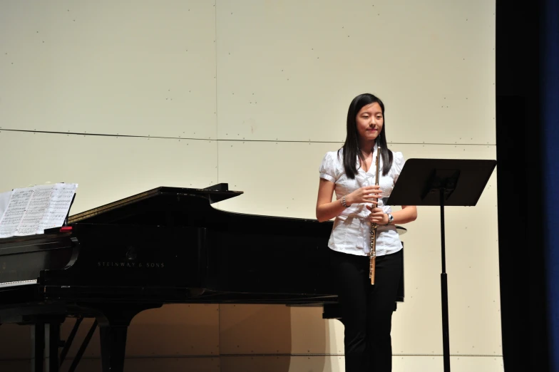 a young woman is playing a music instrument in front of an instrument