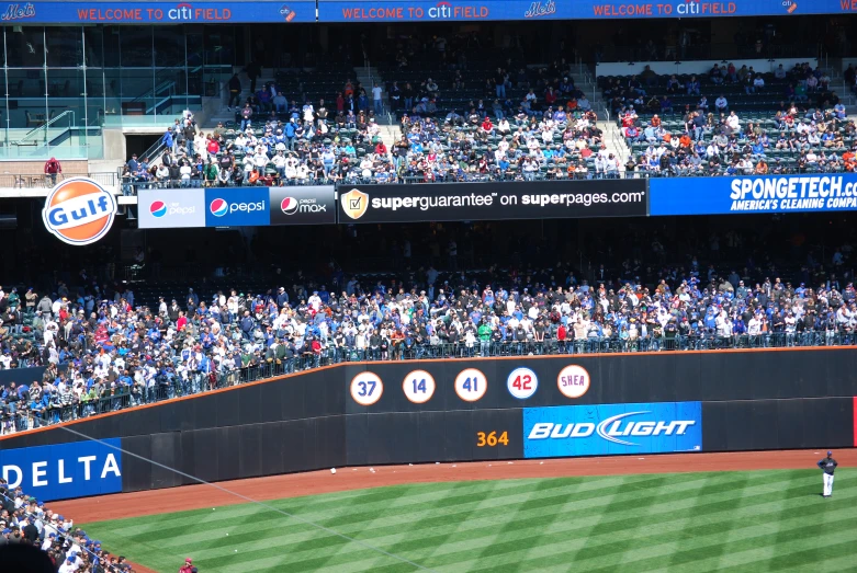 baseball stadium with lots of spectators watching the game