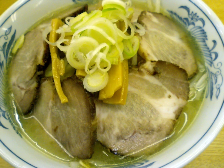 a bowl of food with onions and meat