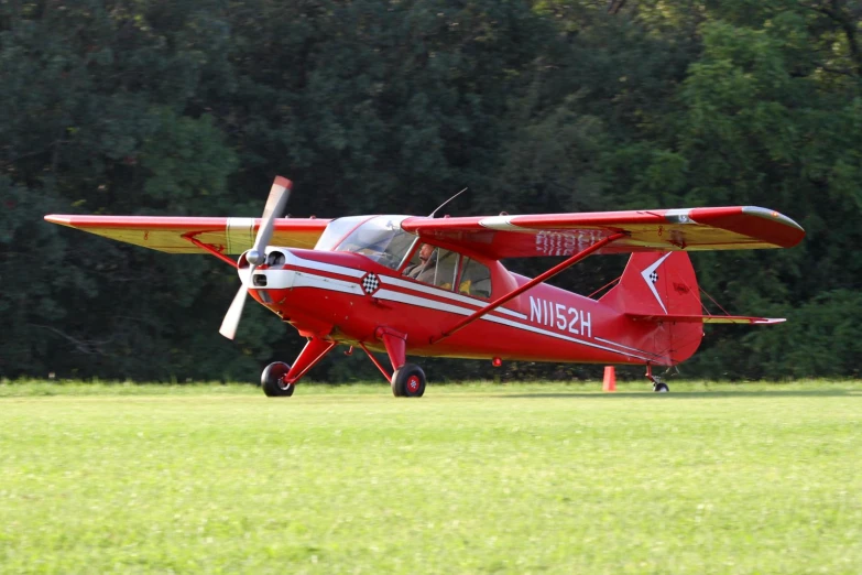 the small plane is red with white stripes