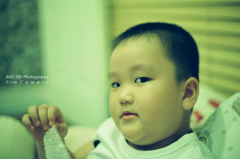 there is a baby that is sitting on the bed