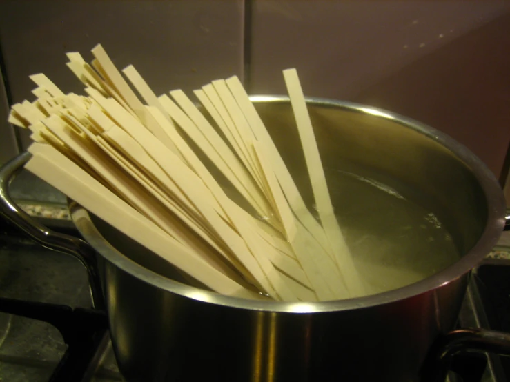 chopsticks are put into a pot with water