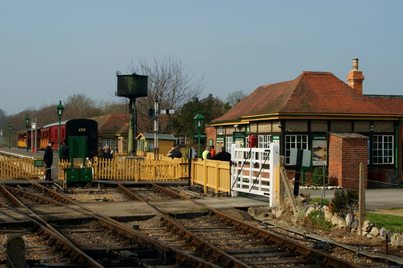 a small train sits at the station waiting for passengers