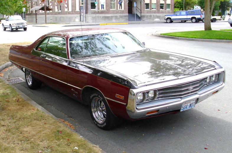 an older looking car parked in a lot