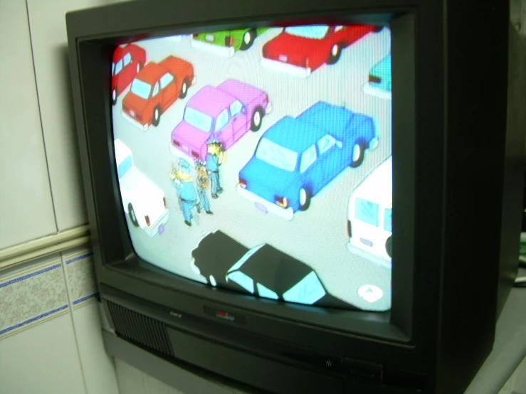 there is a tv with cars on it in the room