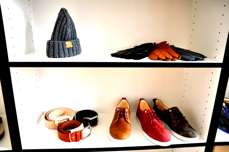 a shelf has hats and shoes on it